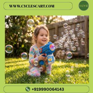 Young girl smiling and sitting on a green lawn playing with the electric blue bubble blaster gun surrounded by bubbles | Cyclescart